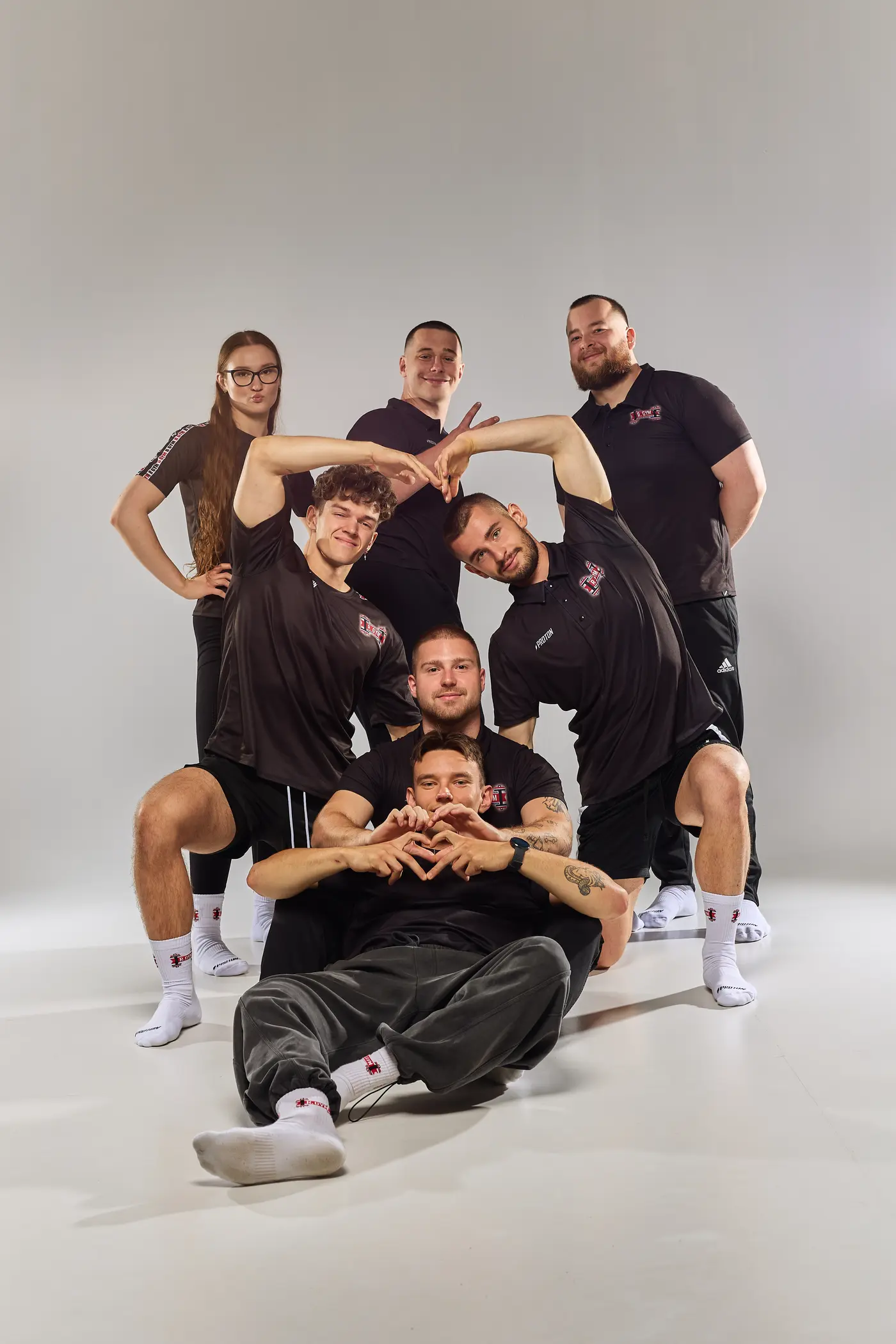 Ekipa R.GYM podczas wspólnej sesji, z żartobliwymi sercami ułożonymi z dłoni